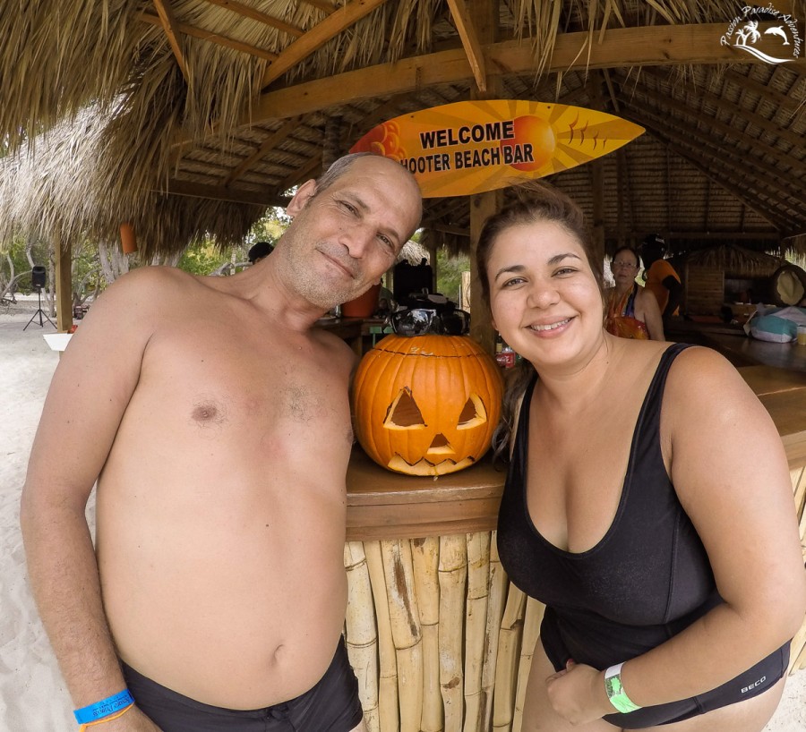 Guest enjoying their photo taken with the pumpkin our private beach bar on Catalina Island